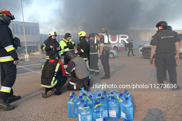 Rescuers are gathering outside an Epicentr K construction supermarket hit with two Russian glide bombs in Kharkiv, Ukraine, on May 25, 2024....