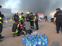 Rescuers are gathering outside an Epicentr K construction supermarket hit with two Russian glide bombs in Kharkiv, Ukraine, on May 25, 2024....