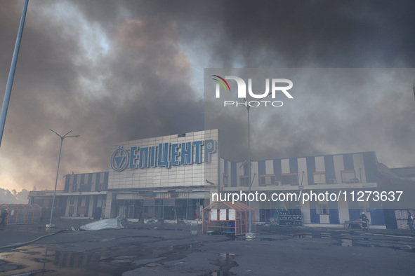 Smoke is rising over an Epicentr K construction supermarket hit with two Russian glide bombs in Kharkiv, Ukraine, on May 25, 2024. At least...