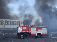 A fire engine is being seen outside an Epicentr K construction supermarket hit with two Russian glide bombs in Kharkiv, Ukraine, on May 25,...