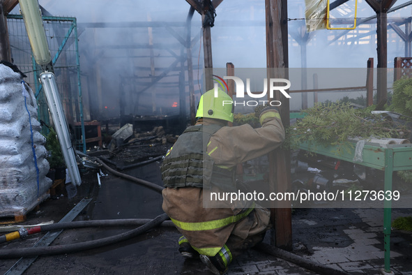 A rescuer is responding to a Russian glide bomb attack on an Epicentr K construction supermarket in Kharkiv, Ukraine, on May 25, 2024. At le...