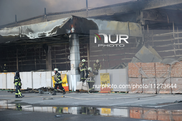 Rescuers are responding to a Russian glide bomb attack on an Epicentr K construction supermarket in Kharkiv, Ukraine, on May 25, 2024. At le...