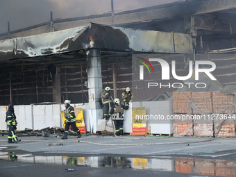 Rescuers are responding to a Russian glide bomb attack on an Epicentr K construction supermarket in Kharkiv, Ukraine, on May 25, 2024. At le...