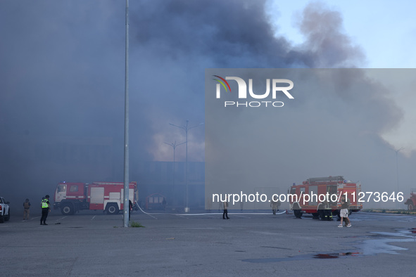 Fire engines are being seen outside an Epicentr K construction supermarket hit with two Russian glide bombs in Kharkiv, Ukraine, on May 25,...