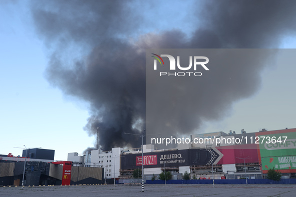 Smoke is rising over an Epicentr K construction supermarket hit with two Russian glide bombs in Kharkiv, Ukraine, on May 25, 2024. At least...