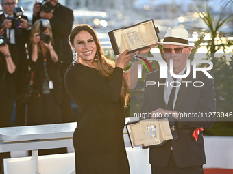 Jacques Audiard is posing with the 'Jury Prize' Award for 'Emilia Perez' and Karla Sofia Gascon is posing with the 'Best Actress' Award for...