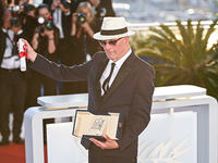 Jacques Audiard is posing with the 'Jury Prize' Award for 'Emilia Perez' during the Palme D'Or Winners Photocall at the 77th annual Cannes F...