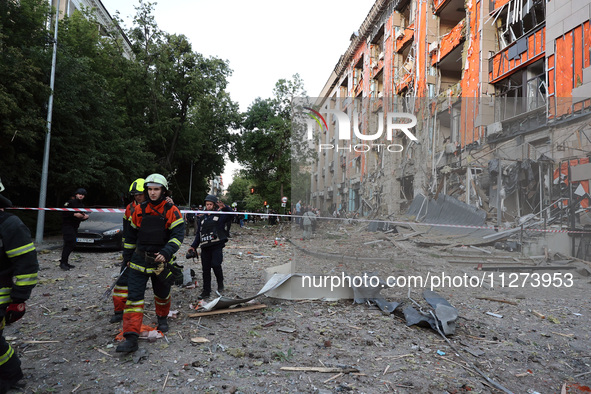 Rescuers are seen outside an office building destroyed by a Russian missile strike in central Kharkiv, Ukraine, on May 25, 2024. NO USE RUSS...