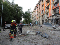 Rescuers are seen outside an office building destroyed by a Russian missile strike in central Kharkiv, Ukraine, on May 25, 2024. NO USE RUSS...