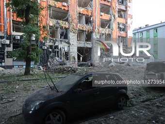 A damaged car is being seen opposite an office building destroyed in a Russian missile strike in central Kharkiv, Ukraine, on May 25, 2024....