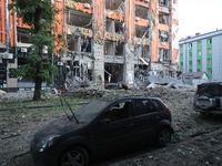 A damaged car is being seen opposite an office building destroyed in a Russian missile strike in central Kharkiv, Ukraine, on May 25, 2024....