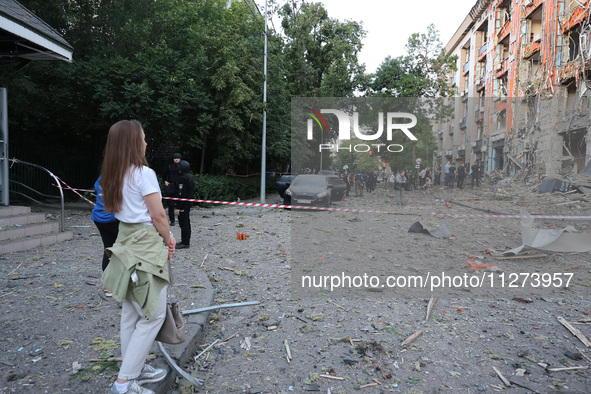 A woman is looking at an office building destroyed by a Russian missile strike in central Kharkiv, Ukraine, on May 25, 2024. NO USE RUSSIA....