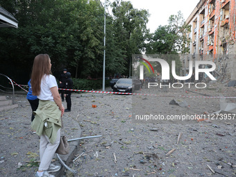 A woman is looking at an office building destroyed by a Russian missile strike in central Kharkiv, Ukraine, on May 25, 2024. NO USE RUSSIA....