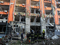 Rescuers are seen outside an office building destroyed by a Russian missile strike in central Kharkiv, Ukraine, on May 25, 2024. NO USE RUSS...