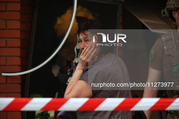 A woman is crying near an office building destroyed by a Russian missile strike in central Kharkiv, Ukraine, on May 25, 2024. NO USE RUSSIA....