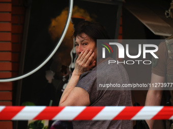 A woman is crying near an office building destroyed by a Russian missile strike in central Kharkiv, Ukraine, on May 25, 2024. NO USE RUSSIA....