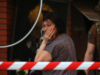 A woman is crying near an office building destroyed by a Russian missile strike in central Kharkiv, Ukraine, on May 25, 2024. NO USE RUSSIA....