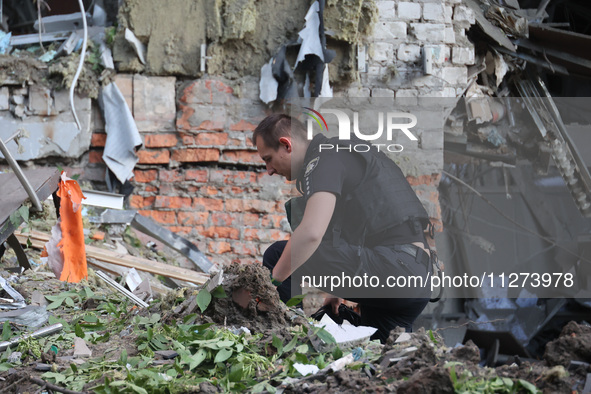 A police officer is exploring the premises of an office building destroyed by a Russian missile strike in central Kharkiv, Ukraine, on May 2...