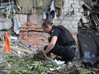 A police officer is exploring the premises of an office building destroyed by a Russian missile strike in central Kharkiv, Ukraine, on May 2...