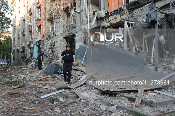 Police officers are exploring the premises of an office building destroyed by a Russian missile strike in central Kharkiv, Ukraine, on May 2...