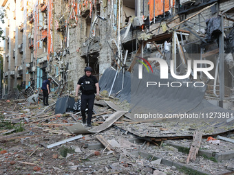 Police officers are exploring the premises of an office building destroyed by a Russian missile strike in central Kharkiv, Ukraine, on May 2...