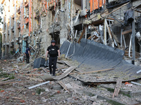 Police officers are exploring the premises of an office building destroyed by a Russian missile strike in central Kharkiv, Ukraine, on May 2...