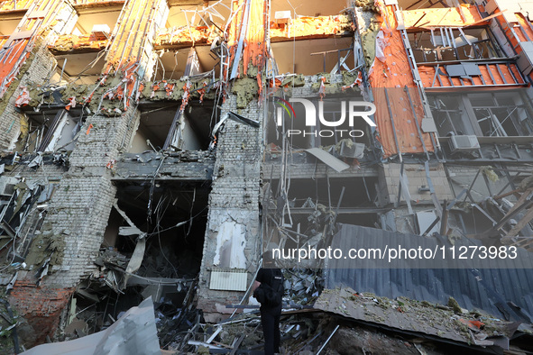 A police officer is exploring the premises of an office building destroyed by a Russian missile strike in central Kharkiv, Ukraine, on May 2...