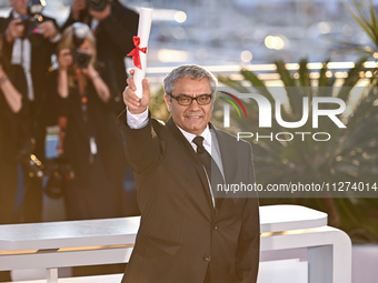 Mohammad Rasoulof is posing with the 'Special Award for Best Screenplay' for 'The Seed of the Sacred Fig' during the Palme D'Or Winners Phot...