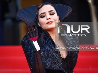  Asmae El Moudir, wearing a glove with the flag of Palestine, attends the Red Carpet of the closing ceremony at the 77th annual Cannes Film...