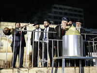 Ultra-Orthodox Jewish men watch a fire burn as they celebrate the Jewish holiday of Lag BaOmer in the Sheikh Jarrah neighborhood of Israeli-...