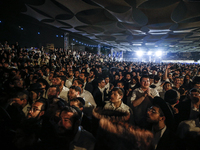 Ultra-Orthodox Jewish men watch a fire burn as they celebrate the Jewish holiday of Lag BaOmer in the Sheikh Jarrah neighborhood of Israeli-...