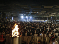 Ultra-Orthodox Jewish men watch a fire burn as they celebrate the Jewish holiday of Lag BaOmer in the Sheikh Jarrah neighborhood of Israeli-...