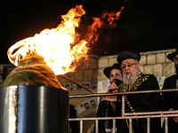 Ultra-Orthodox Jewish men watch a fire burn as they celebrate the Jewish holiday of Lag BaOmer in the Sheikh Jarrah neighborhood of Israeli-...