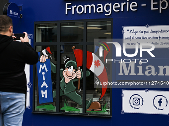 CARPIQUET, FRANCE - MAY 24: 
A D-Day related images painted in a local businesses windows, on May 24, 2024, in Carpiquet, Caen, France (