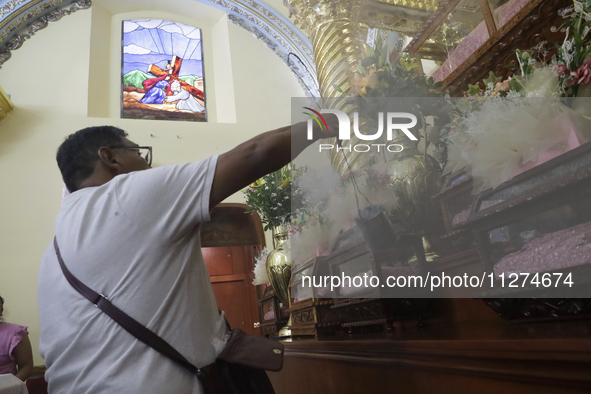 An inhabitant of Culhuacan in the extreme south of Mexico City is attending a mass at the Sanctuary of the Lord of Calvary on the eve of the...