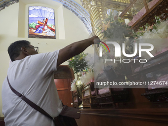 An inhabitant of Culhuacan in the extreme south of Mexico City is attending a mass at the Sanctuary of the Lord of Calvary on the eve of the...