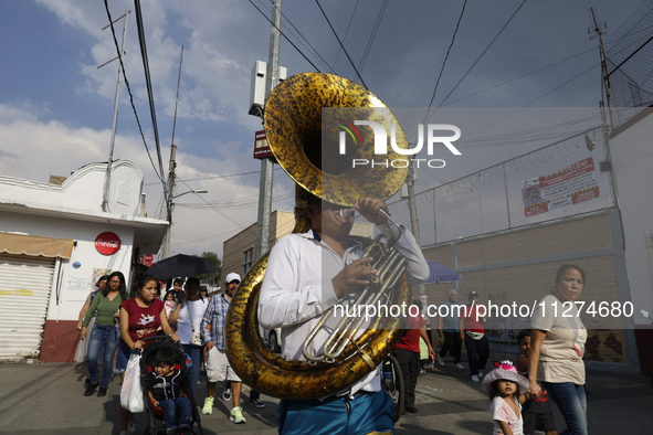 Musicians are accompanying residents of Culhuacan in the southernmost part of Mexico City during a procession to the Sanctuary of the Lord o...