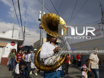 Musicians are accompanying residents of Culhuacan in the southernmost part of Mexico City during a procession to the Sanctuary of the Lord o...