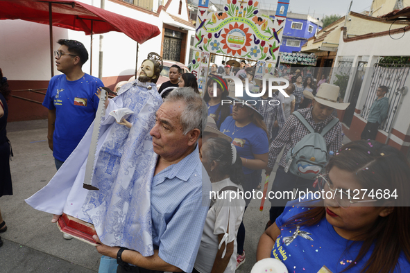 Inhabitants of Culhuacan in the extreme south of Mexico City are carrying religious images during a procession to the Sanctuary of the Lord...