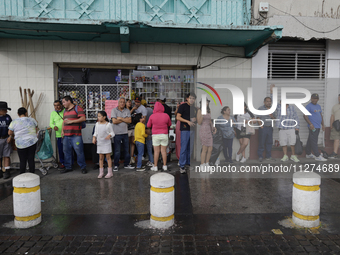 Residents of Culhuacan in the far south of Mexico City are sheltering from the rain during a procession to the Sanctuary of the Lord of Calv...