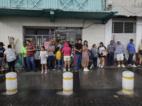 Residents of Culhuacan in the far south of Mexico City are sheltering from the rain during a procession to the Sanctuary of the Lord of Calv...