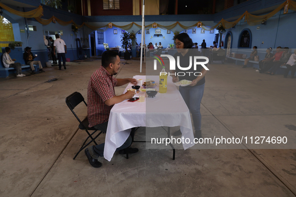 Inhabitants of Culhuacan in the extreme south of Mexico City are convivial during lunchtime at the end of a procession to the Sanctuary of t...