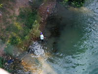 A woman fishes in the Rio Grande River in Piedras Negras, Mexico on May 25, 2024. (