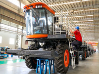 Workers are assembling packing cotton picking machines at the Railway Construction Heavy Industry Xinjiang Co LTD in the economic and Techno...