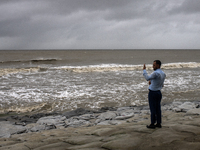 A man is taking pictures of waves at Kuakata Sea Beach in the southern part of Bangladesh on May 26, 2024, ahead of Cyclone Remal. The Met O...