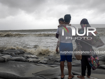 A child is reacting to the camera as she is visiting Kuakata Sea Beach with her parents in the southern part of Bangladesh, on May 26, 2024,...