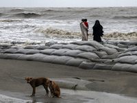 Tourists are walking through Kuakata Sea Beach in southern Bangladesh, on May 26, 2024, as Cyclone Remal nears. The Met Office is issuing a...