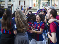 Supporters of Barca are celebrating victory in the UEFA Women's Champions League final at the Canaletes fountain in Barcelona, Spain, on May...