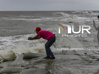 A man is taking a picture at Kuakata sea beach area in Kuakata, Bangladesh, on May 26, 2024, ahead of Cyclone Remal landfall in the coastal...