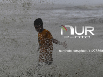 A boy is trying to escape from a wave at Kuakata beach area in Kuakata, Bangladesh, on May 26, 2024, ahead of Cyclone Remal landfall. Bangla...